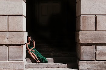 Woman Sitting In Shadows On A Staircase