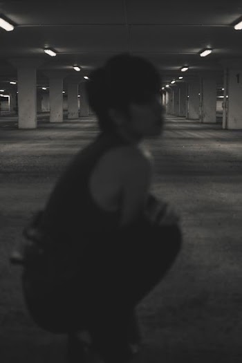 woman sitting inside parking lot