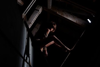 woman sitting inside room with low light