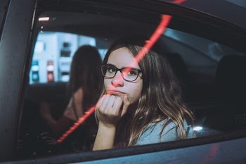 woman sitting inside vehicle frowning