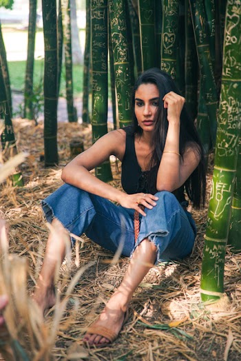 Woman Sitting Near Bamboos