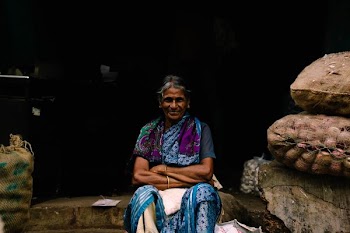woman sitting near brown sacks