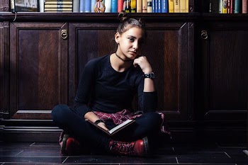 woman sitting near cabinet