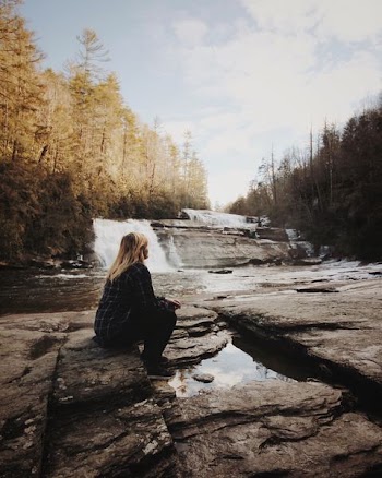 woman sitting near falls