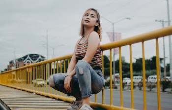 Woman Sitting Near Fence