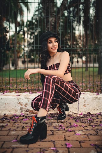 Woman Sitting Near Fence