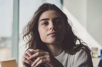 woman sitting near glass window