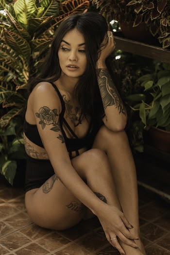 Woman Sitting Near Plants
