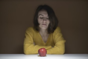 Woman Sitting Near Red Apple Fruit