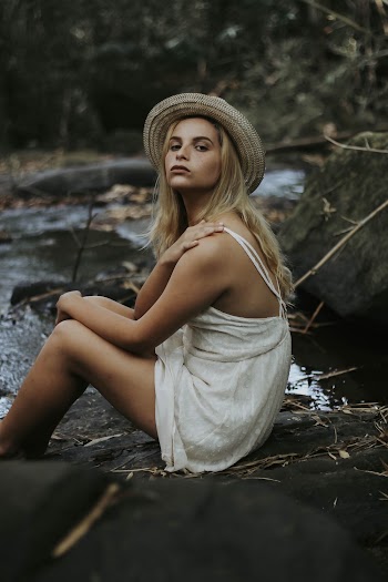 Woman Sitting Near River
