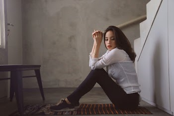 Woman Sitting Near Staircase