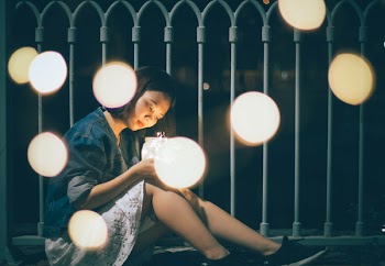 Woman Sitting Near the Rail