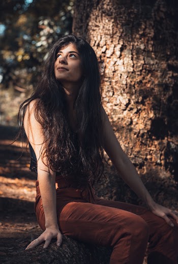 Woman Sitting Near Tree