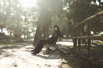 Woman Sitting on a Bench