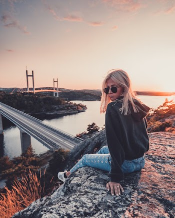 Woman Sitting on a Cliff
