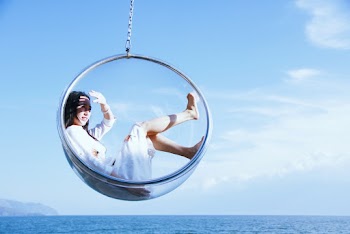 Woman Sitting On A Glass Hanging Chair