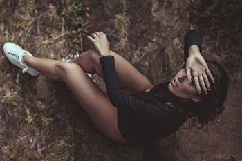 Woman Sitting On A Rock 