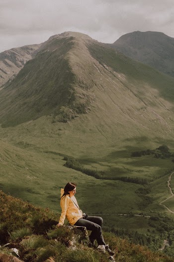 Woman Sitting On A Rock