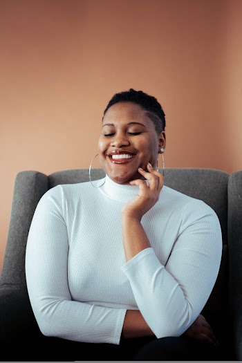 Woman Sitting on a Sofa Chair