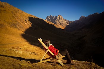 Woman Sitting On Adirondack Chair