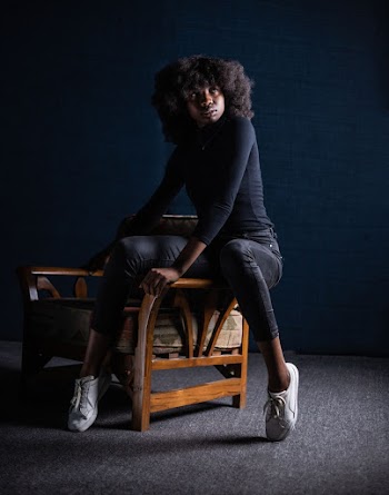 Woman Sitting on Armchair's Arm