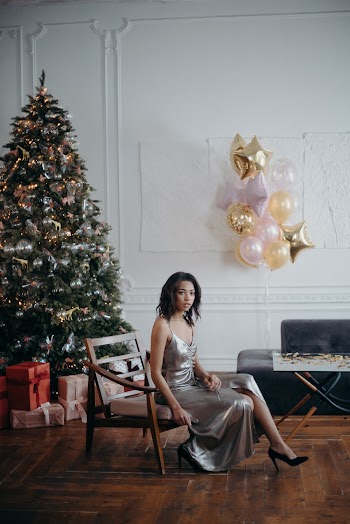 Woman Sitting on Armchair Near Christmas Tree