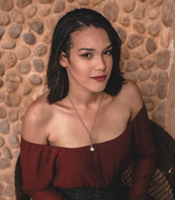 Woman Sitting on Armchair Smiling