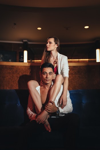 Woman Sitting on Backrest Legs on Man's Shoulder