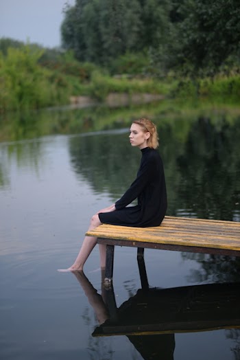 Woman Sitting On Bamboo Dock
