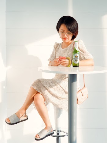 Woman Sitting on Bar Stool