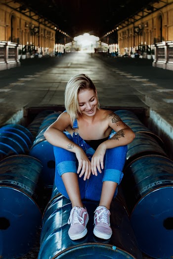 Woman Sitting On Barrels