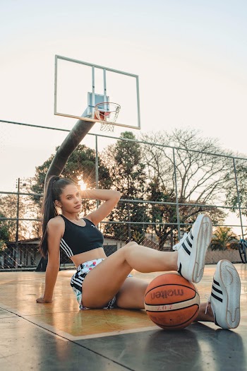 Woman Sitting on Basketball Court