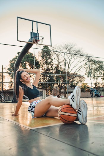Woman Sitting on Basketball Court