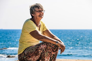Woman Sitting on Beach Shore