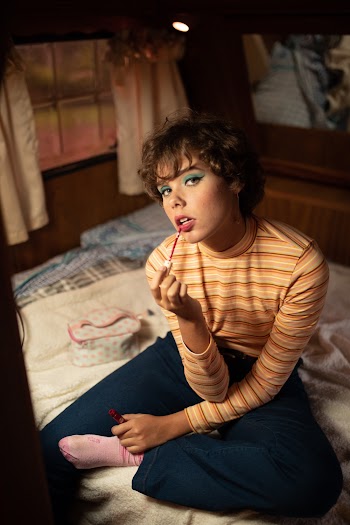 Woman Sitting on Bed