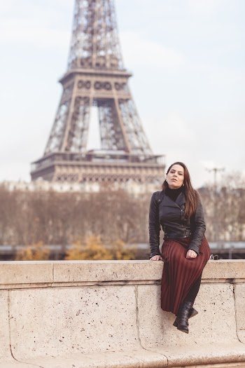 Woman Sitting on Beige Stone Rail Near Eiffel Tower in Paris, France