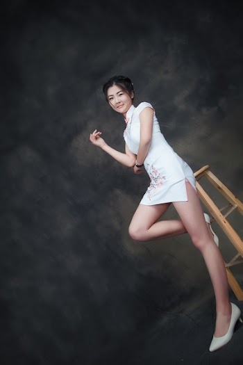 Woman Sitting on Beige Wooden Stool
