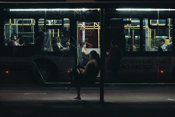 Woman Sitting on Bench during Nighttime