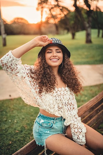 Woman Sitting on Bench in Park