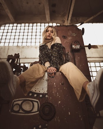 Woman Sitting on Bench Inside Building