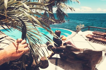 Woman Sitting on Bench Near Pool