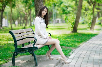 Woman Sitting on Bench Near Tree