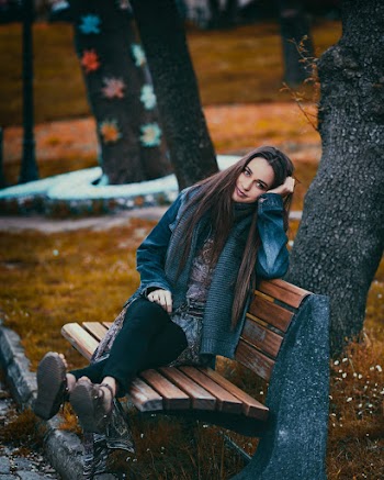 Woman Sitting on Bench Near Trees