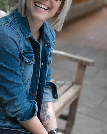 Woman Sitting on Bench Smiling