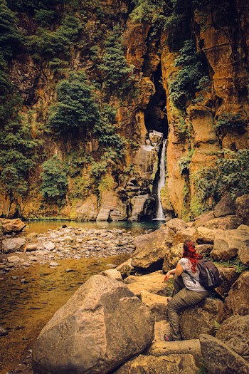 Woman Sitting On Big Rocks