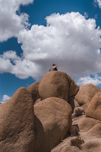 Woman Sitting on Big Stones