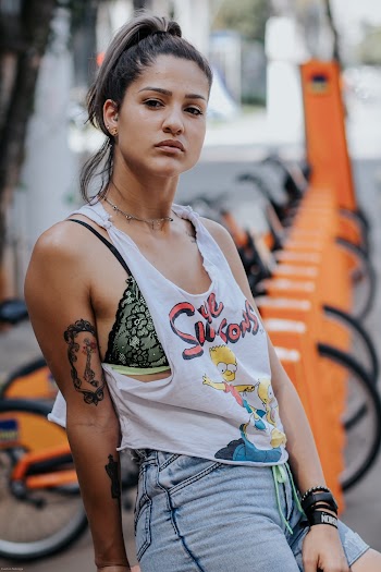 Woman Sitting on Bike Rack
