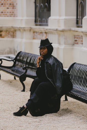 Woman Sitting on Black Bench