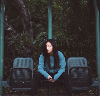 woman sitting on black chair