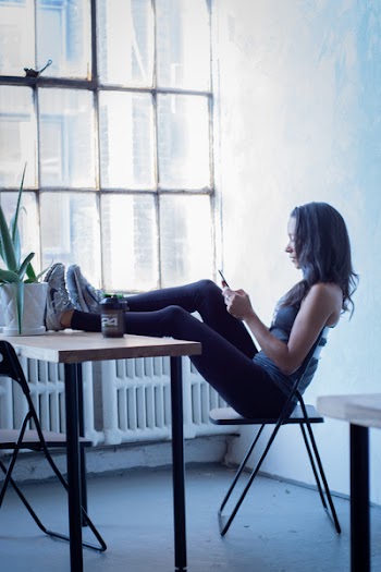 Woman Sitting On Black Folding Chair